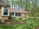 Scenic backyard featuring a screened-in porch, brick home, and a well-manicured lawn with lush garden beds at 10561 Wilson Rd, Brownsburg, IN 46112
