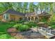 Landscaped backyard featuring a small bridge over a rock garden, with mature trees at 10561 Wilson Rd, Brownsburg, IN 46112