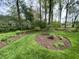 A backyard featuring lush green grass and landscaped garden beds with mulch, creating a serene outdoor space at 10561 Wilson Rd, Brownsburg, IN 46112