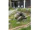 Manicured backyard with brick patio, stone pathway, potted plants, and outdoor seating at 10561 Wilson Rd, Brownsburg, IN 46112