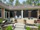 Backyard patio with potted plants, outdoor seating, and a screened-in porch, offering a serene outdoor living space at 10561 Wilson Rd, Brownsburg, IN 46112