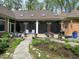 A backyard patio area featuring potted plants, patio furniture, and a view of the house with skylights at 10561 Wilson Rd, Brownsburg, IN 46112
