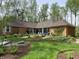 Beautiful backyard featuring a patio, lush landscaping, and a charming brick home, perfect for outdoor living and entertaining at 10561 Wilson Rd, Brownsburg, IN 46112