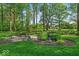A beautifully landscaped backyard with mature trees, bridge, and decorative lantern at 10561 Wilson Rd, Brownsburg, IN 46112