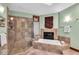 Bright bathroom featuring a luxurious soaking tub and glass enclosed shower at 10561 Wilson Rd, Brownsburg, IN 46112