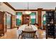 Formal dining room featuring a table with seating, wood trim, and beautiful backyard views at 10561 Wilson Rd, Brownsburg, IN 46112