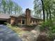 Exterior side view of a brick home with a stone pathway and manicured landscaping at 10561 Wilson Rd, Brownsburg, IN 46112