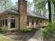 Exterior side view of a brick home with a stone pathway and manicured landscaping at 10561 Wilson Rd, Brownsburg, IN 46112