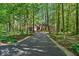 Scenic driveway leading to a brick home surrounded by lush trees providing privacy and shade at 10561 Wilson Rd, Brownsburg, IN 46112