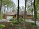 View of a single story home with a brick exterior, attached garage, driveway and yard landscaping at 10561 Wilson Rd, Brownsburg, IN 46112