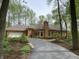 View of a single story home with a brick exterior, attached garage, driveway and yard landscaping at 10561 Wilson Rd, Brownsburg, IN 46112