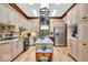Well-lit kitchen with stainless steel appliances, center island, custom cabinetry, and hardwood floors at 10561 Wilson Rd, Brownsburg, IN 46112