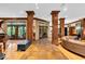 Spacious living room featuring tile floors, wooden pillars, french doors, and an open layout at 10561 Wilson Rd, Brownsburg, IN 46112