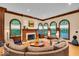 Inviting living room highlighting a fireplace, large windows, hardwood floors, and a sectional sofa at 10561 Wilson Rd, Brownsburg, IN 46112