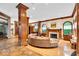Cozy living room featuring wood floors, a fireplace, large windows, and comfortable seating at 10561 Wilson Rd, Brownsburg, IN 46112