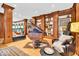 Elegant living room with hardwood floors, built-in shelving, a piano, and ample seating at 10561 Wilson Rd, Brownsburg, IN 46112