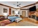 Serene main bedroom with a cozy fireplace, hardwood floors, and a ceiling fan at 10561 Wilson Rd, Brownsburg, IN 46112
