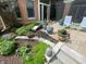 Charming backyard patio with potted plants, a sitting area, and a stone bench, perfect for relaxing outdoors at 10561 Wilson Rd, Brownsburg, IN 46112