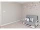 Cozy bedroom with a gray futon featuring accent pillows and a flower decal on the wall at 10810 Arendale Dr, Brownsburg, IN 46112