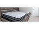 Neutral bedroom featuring a platform bed with a white mattress and a rustic wood frame at 10810 Arendale Dr, Brownsburg, IN 46112