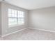 Empty bedroom featuring neutral carpet and walls, blinds on the window, and multiple electrical outlets at 10810 Arendale Dr, Brownsburg, IN 46112