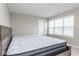 Neutral bedroom featuring a platform bed with a white mattress, neutral walls, and blinds on the window at 10810 Arendale Dr, Brownsburg, IN 46112