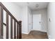 Bright entryway featuring wood floors, neutral paint, and staircase with modern wood railing at 10810 Arendale Dr, Brownsburg, IN 46112