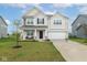 Charming two-story home with a well-manicured lawn, brick accents, and attached two car garage at 10810 Arendale Dr, Brownsburg, IN 46112