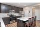 Well-equipped kitchen with dark cabinetry, stainless steel appliances, and a center island with seating at 10810 Arendale Dr, Brownsburg, IN 46112