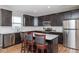 Modern kitchen with dark wood cabinets, stainless steel appliances, and a center island with bar seating at 10810 Arendale Dr, Brownsburg, IN 46112