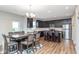 Modern kitchen and dining area with dark cabinetry, stainless steel appliances, and breakfast bar seating at 10810 Arendale Dr, Brownsburg, IN 46112