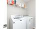 Bright laundry room includes a modern, front-load Maytag washer and dryer, and ample shelving at 10810 Arendale Dr, Brownsburg, IN 46112