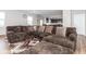 Comfortable living room featuring a plush sofa, stylish pillows, and a seamless transition to the modern kitchen at 10810 Arendale Dr, Brownsburg, IN 46112