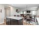 Open-concept living space with kitchen island, dining area, and sitting room featuring a pool table and fireplace at 10810 Arendale Dr, Brownsburg, IN 46112