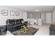 Stylish living room with black leather reclining furniture, modern decor, and neutral colored walls at 10810 Arendale Dr, Brownsburg, IN 46112