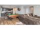 Open floor plan of living room with a pool table and a seamless transition to the modern kitchen at 10810 Arendale Dr, Brownsburg, IN 46112