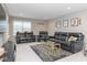 Comfortable living room with black leather reclining furniture, a glass coffee table, and neutral decor at 10810 Arendale Dr, Brownsburg, IN 46112