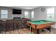 Spacious recreation room featuring a pool table, comfortable seating, and a modern electric fireplace at 10810 Arendale Dr, Brownsburg, IN 46112