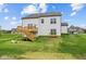 This home features a backyard, with a wooden deck, stairs to the lawn, and landscaping at 1114 Ridgevine Rd, Greenwood, IN 46143