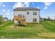 Backyard with a wooden deck, stairs to the lawn, landscaping, and a view of the neighborhood at 1114 Ridgevine Rd, Greenwood, IN 46143