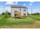A home with a backyard, wooden deck, stairs to the lawn, and landscaping at 1114 Ridgevine Rd, Greenwood, IN 46143