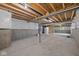 Unfinished basement with concrete floor, exposed ceiling, and access to mechanicals, offering potential for customization at 1114 Ridgevine Rd, Greenwood, IN 46143