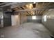 Unfinished basement showcasing exposed ceiling beams and framed walls, offering potential for customization at 1114 Ridgevine Rd, Greenwood, IN 46143