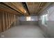 Unfinished basement with concrete floor and walls, exposed ceiling and small window at 1114 Ridgevine Rd, Greenwood, IN 46143