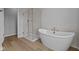 Modern bathroom with a soaking tub and glass-enclosed shower at 1114 Ridgevine Rd, Greenwood, IN 46143