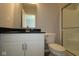 A crisp bathroom features a shower, toilet, and stylish vanity with black countertop at 1114 Ridgevine Rd, Greenwood, IN 46143
