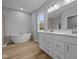 Elegant bathroom featuring double vanity, soaking tub, and light tile accents at 1114 Ridgevine Rd, Greenwood, IN 46143