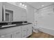 A bathroom with double vanity, granite countertop, and a shower/tub at 1114 Ridgevine Rd, Greenwood, IN 46143