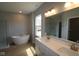 Bright bathroom with a modern tub, separate shower, double sink vanity, and natural light at 1114 Ridgevine Rd, Greenwood, IN 46143