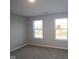 Inviting bedroom featuring neutral walls, plush carpeting, and ample natural light through windows at 1114 Ridgevine Rd, Greenwood, IN 46143